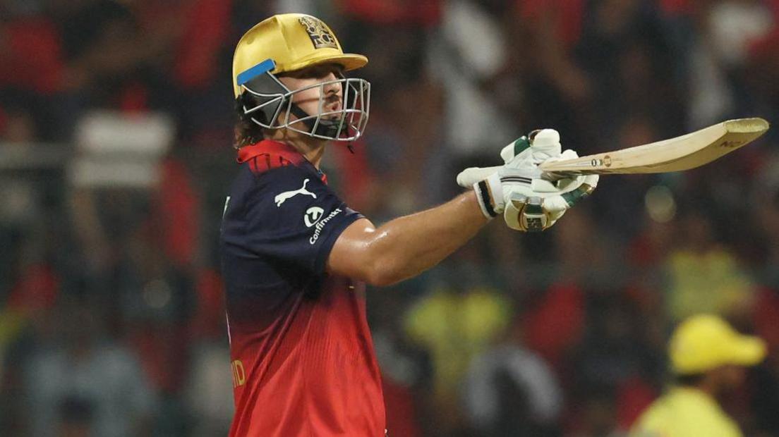RCB's Tim David blows a kiss after reaching fifty against CSK