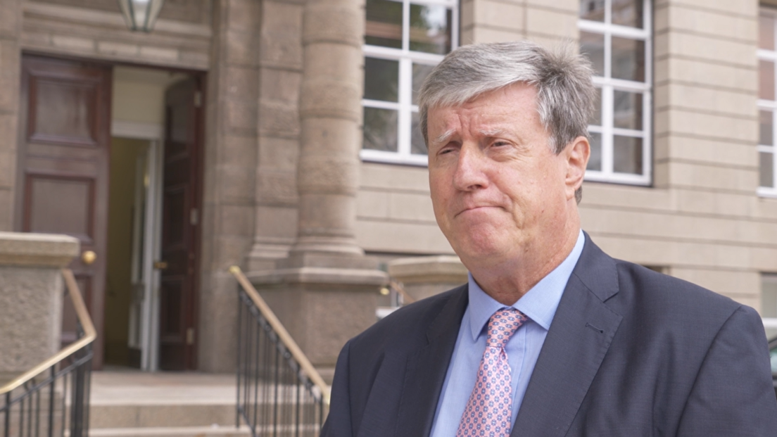 Kevin Lewis outside government building