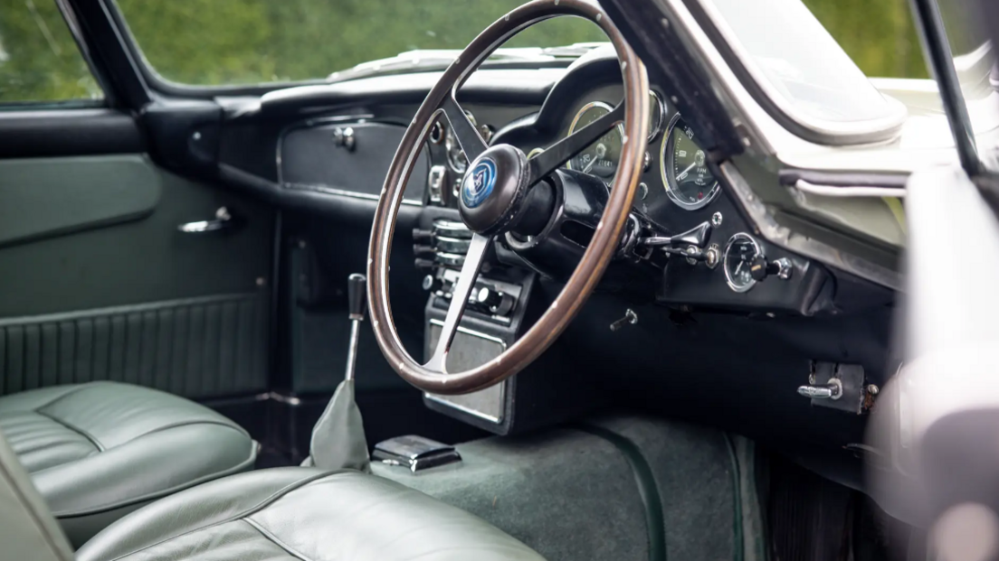 Interior of the DB5 Aston Martin showing sage green leather seats