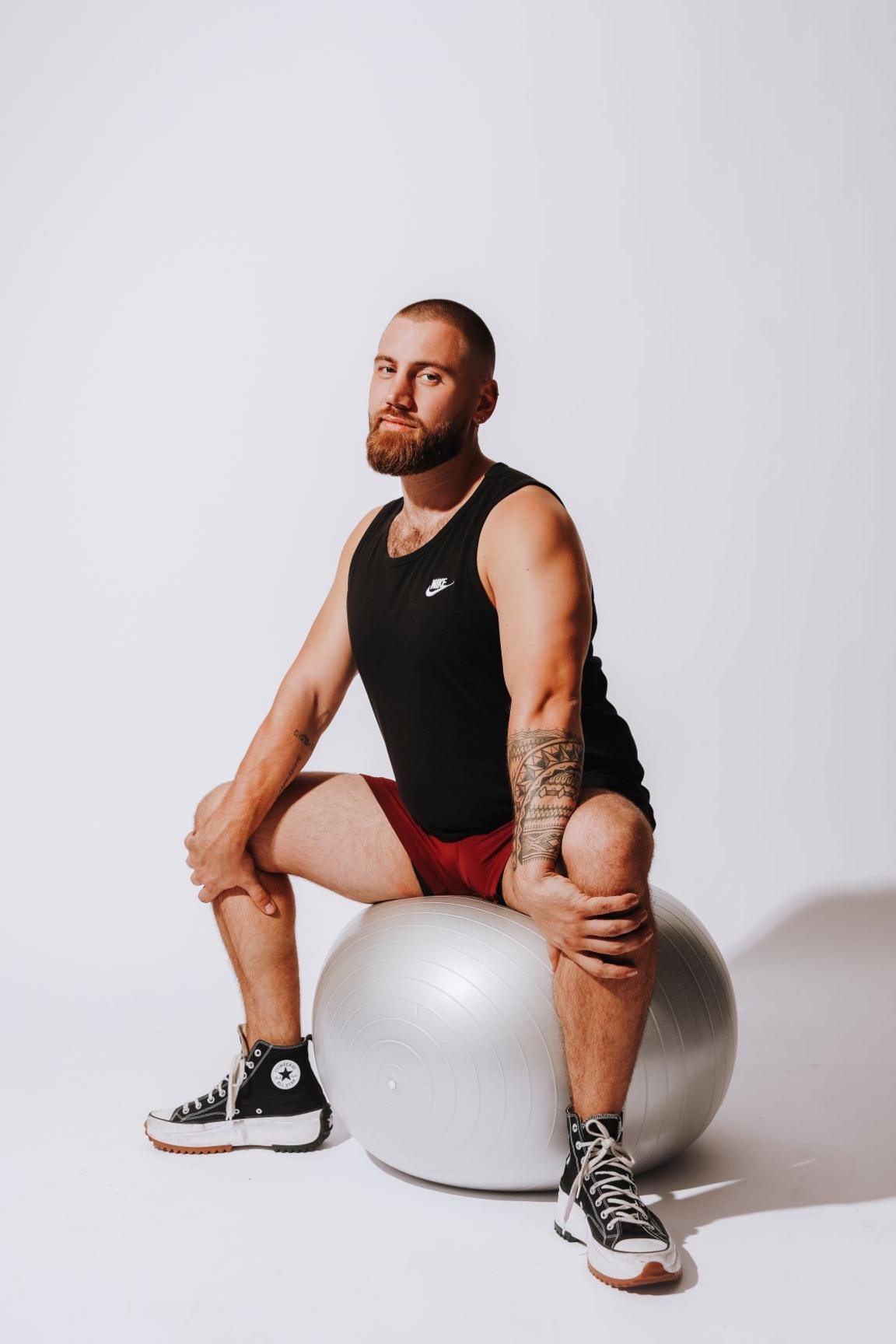 Rees sitting on a yoga ball