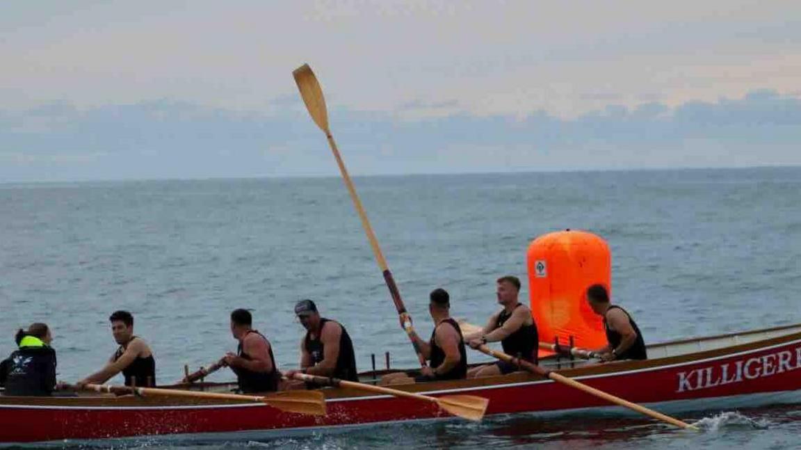 The Falmouth crew in their boat on the water