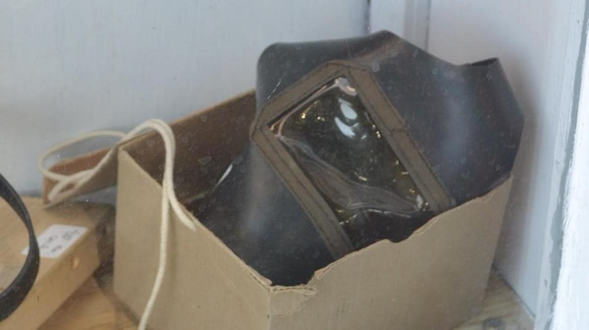 Gas mask in cardboard box