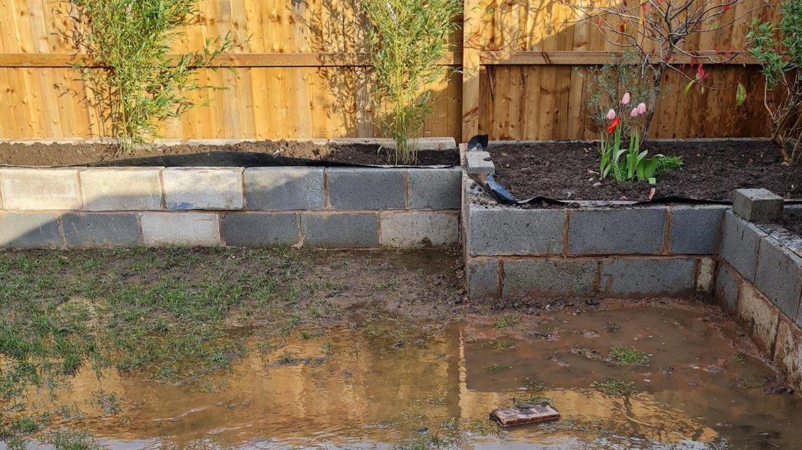 A lawn in a back garden underwater