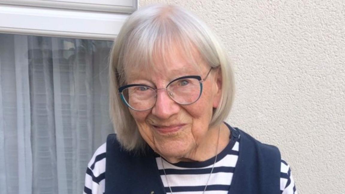 Happy in blue and white wearing glasses outside