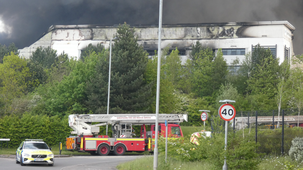 Police and fire outside the scorched building