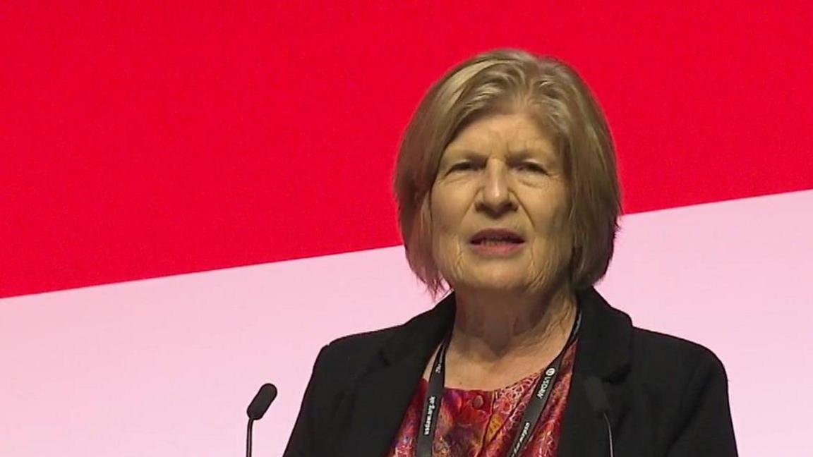 Sally Keeble at a lectern 