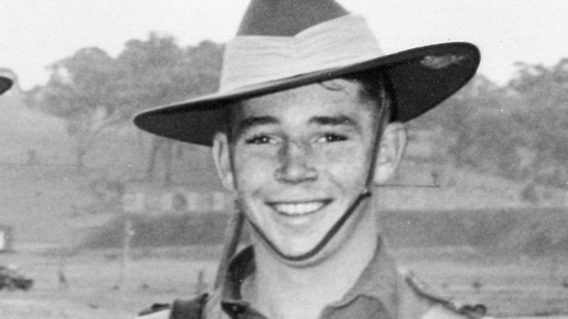 Private Richard Norden in his uniform smiling at the camera