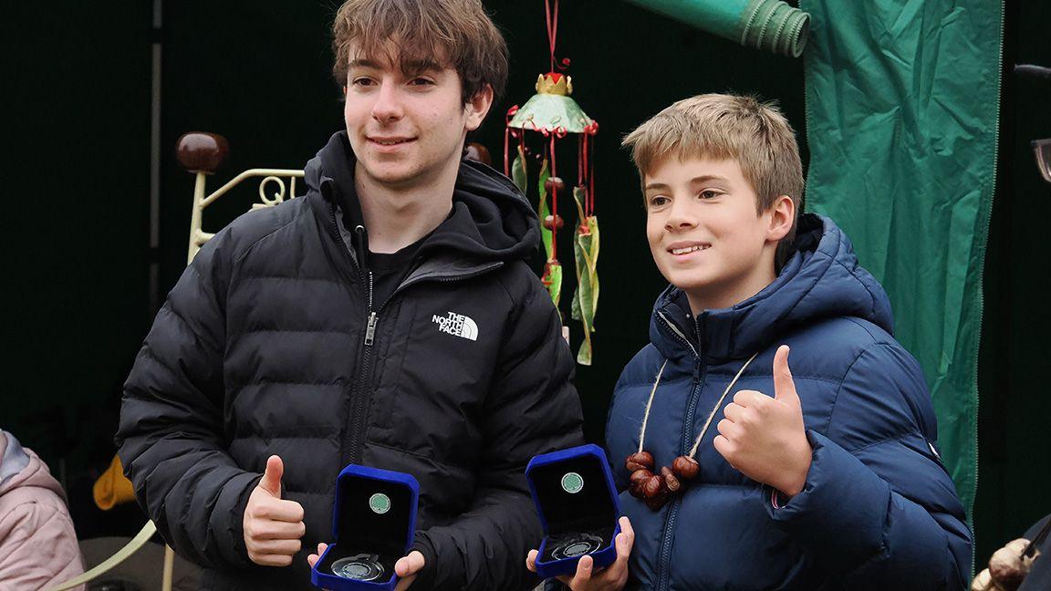 Intermediate champ and runner up pose for a picture with their medals.