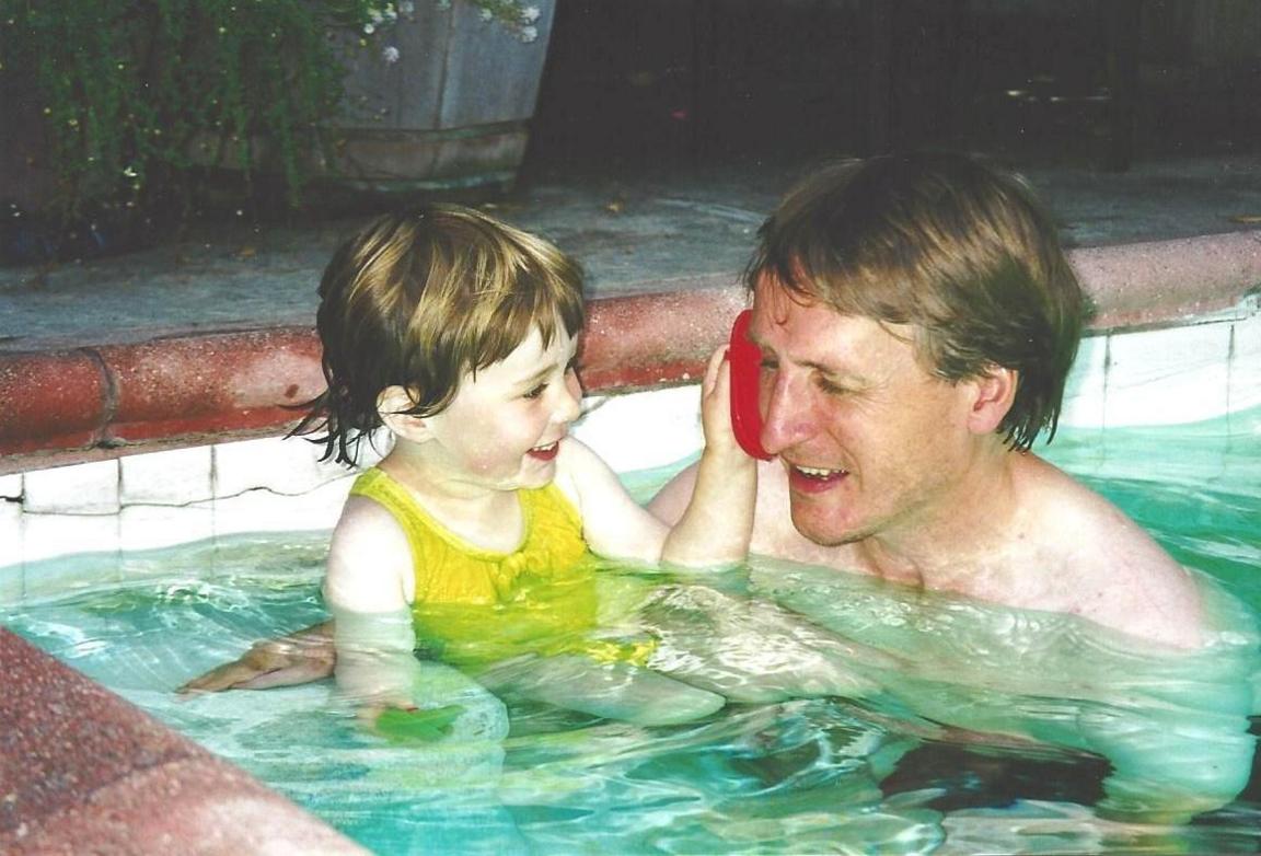 Mike in the swimming pool with Caitlin as a little girl