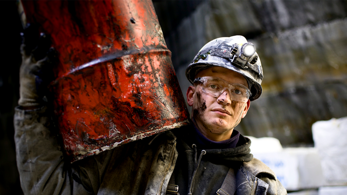 Man carry barrel of oil