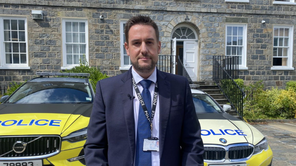 Det Sgt Andy Telford in a suit outside Guernsey Police station