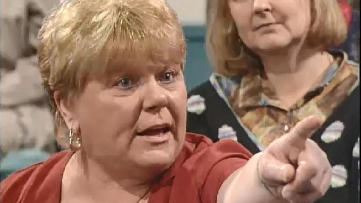 Big Mags on Kilroy. It is a grabbed image from the show. It is a close-up of Haney with her hand out, pointing accusingly. She has bleached blonde hair and a big gold earring.