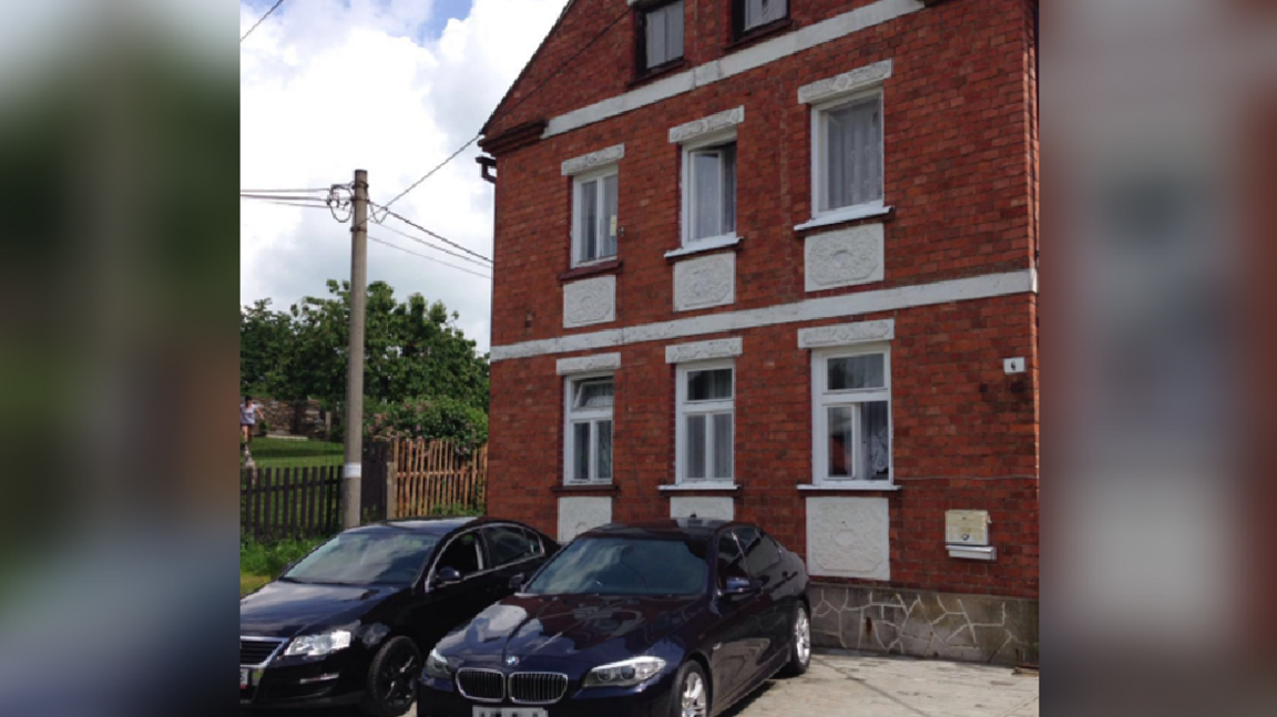 An image taken from the gang's mobile phone showing a BMW and a red-brick property in the Czech Republic