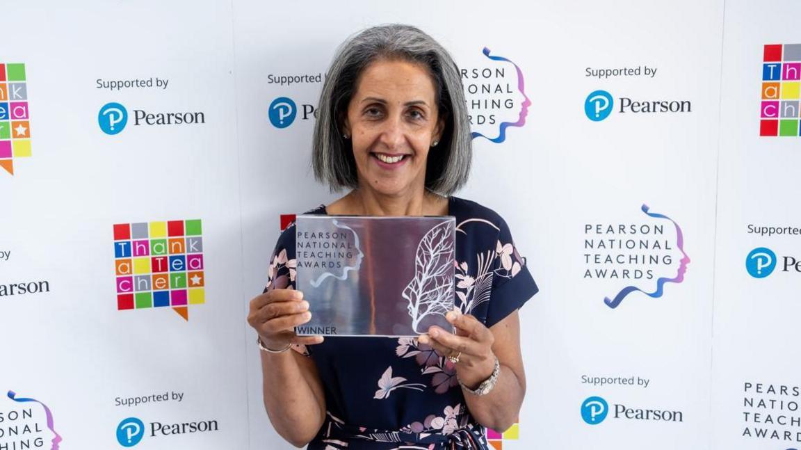 Manjit Nahal holding an award