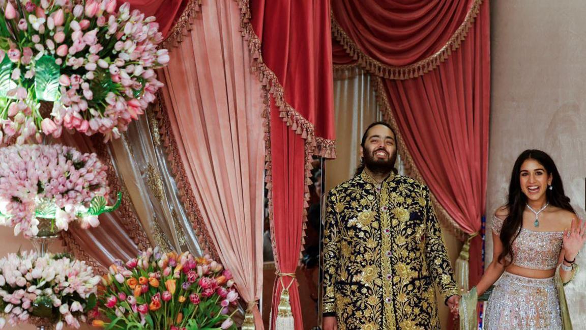 Anant Ambani, son of businessman Mukesh Ambani, arrives with his fiance Radhika Merchant on the red carpet during the sangeet ceremony at Jio World Centre, Mumbai, India, July 5, 2024.