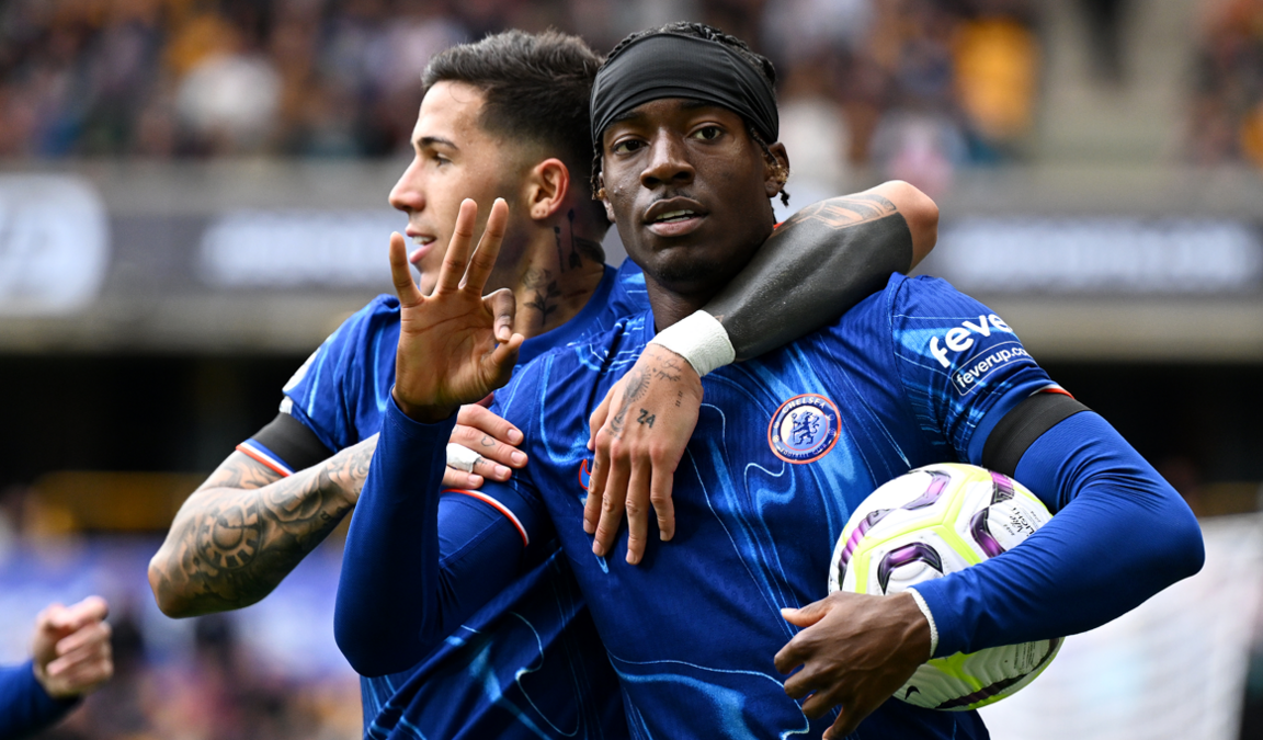 Noni Madueke holding the ball and holding up three fingers to mark his hattrick on Sunday