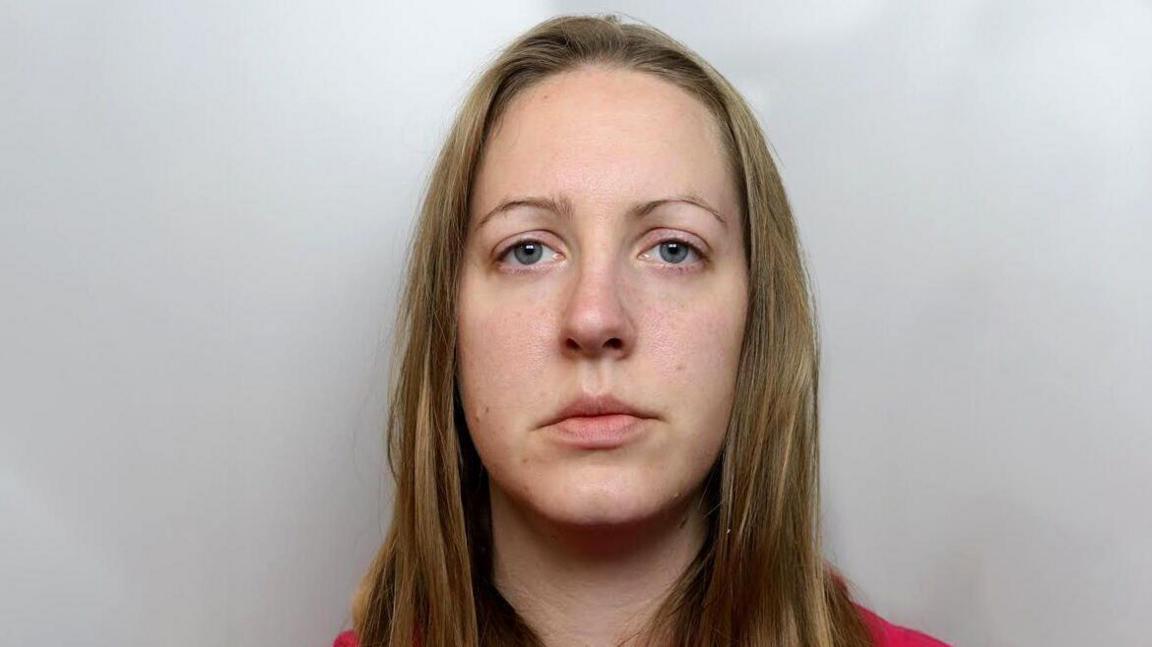 Police mugshot of Lucy Letby, with straight straw-coloured hair, and wearing a pink top