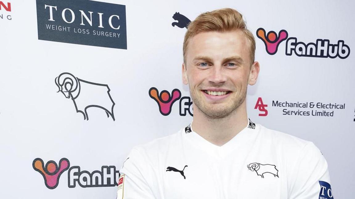 Sondre Langas poses for a picture after his signing by Derby County