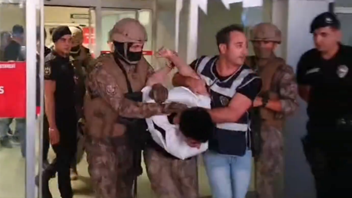 A still of the suspect in a stabbing in Eskisehir, Turkey being escorted from a hospital to a vehicle by police.