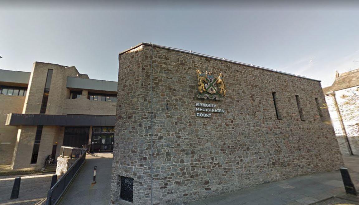 A street view image of the front of Plymouth Magistrates Court. It is a brick building with a red car parked outside the front.