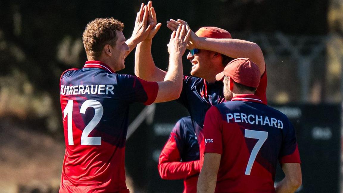 Jersey players celebrate a wicket
