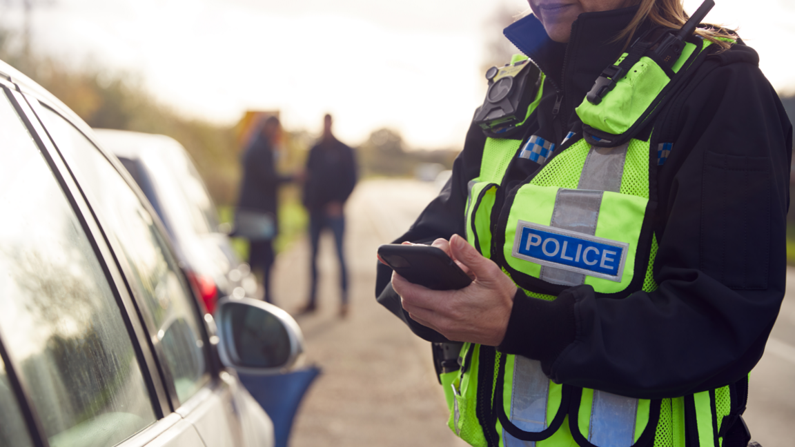 A roads policing officer speaking to a driver