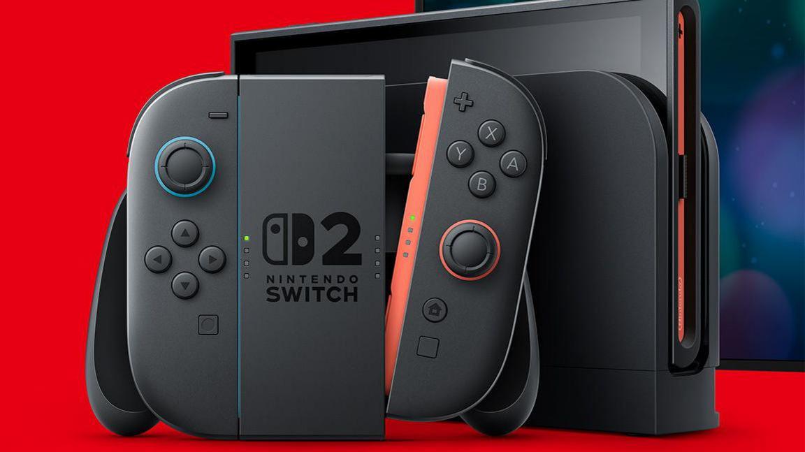 A black Nintendo Joycon controller and console displayed against a bright red background. The central panel has a Nintendo Switch logo with a large numeral 2 alongside it. One of the joycons is detached from the main joypad unit, showing a red connector trim.