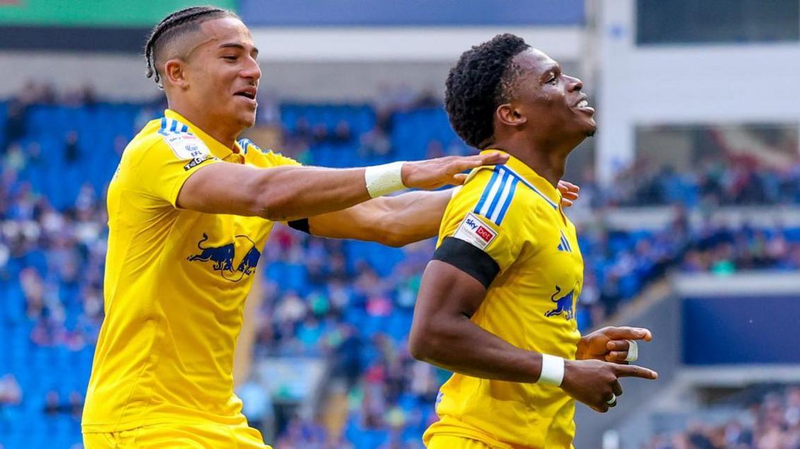 Leeds United midfielder Largie Ramazani (R) scores a goal and celebrates to make the score 0-1 during the EFL Sky Bet Championship match between Cardiff City and Leeds United at the Cardiff City Stadium, Cardiff