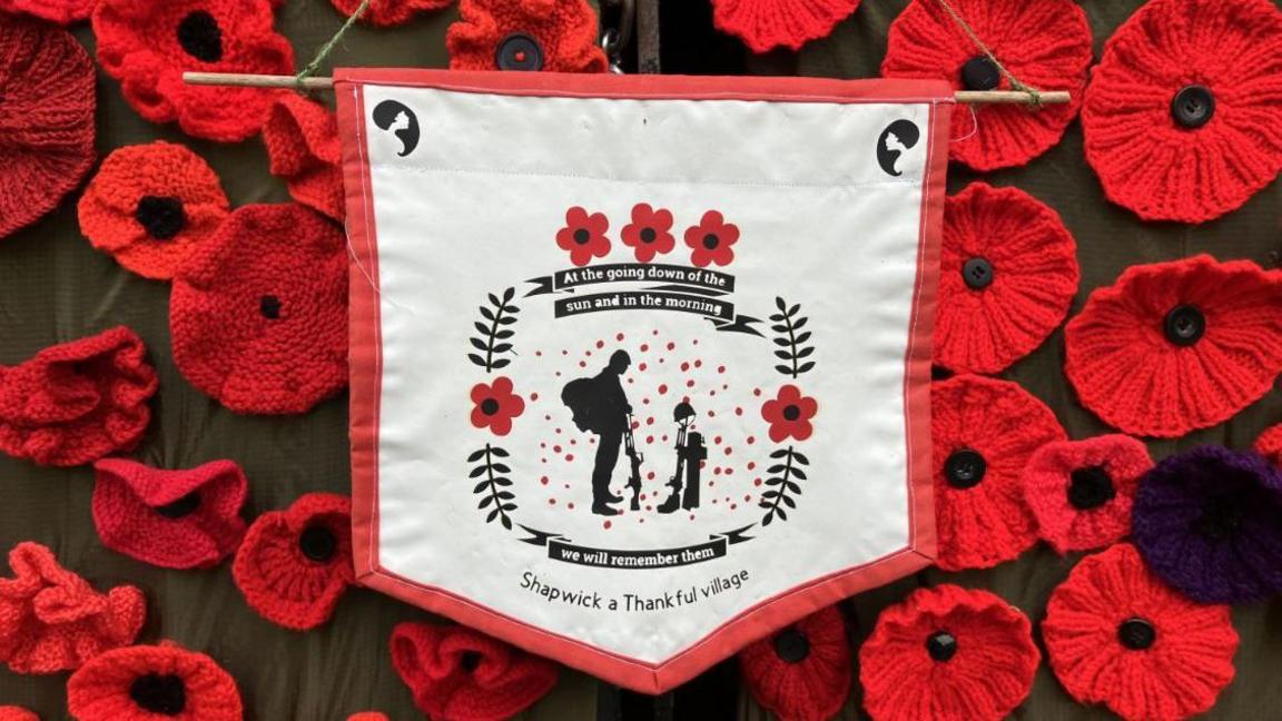 Knitted poppies on the door of a church. 