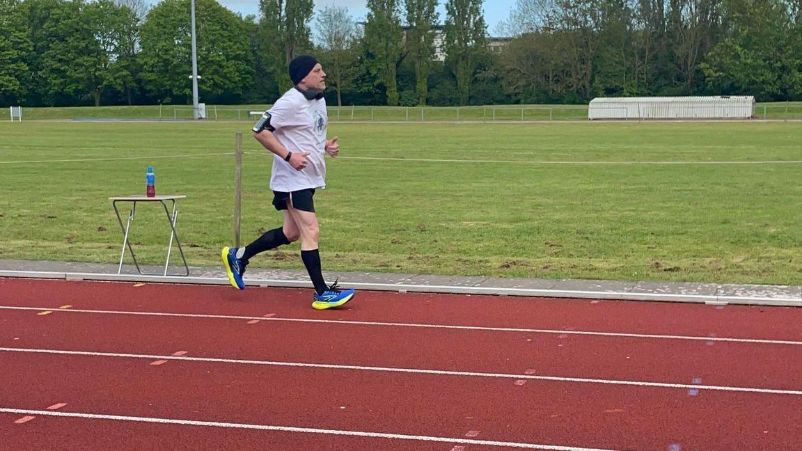 Jason running on the athletics track 