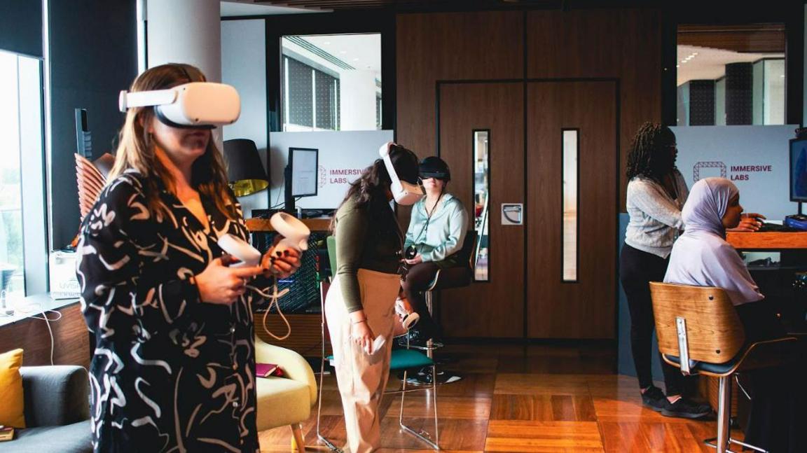 People wearing VR headsets inside an Immersive Lab