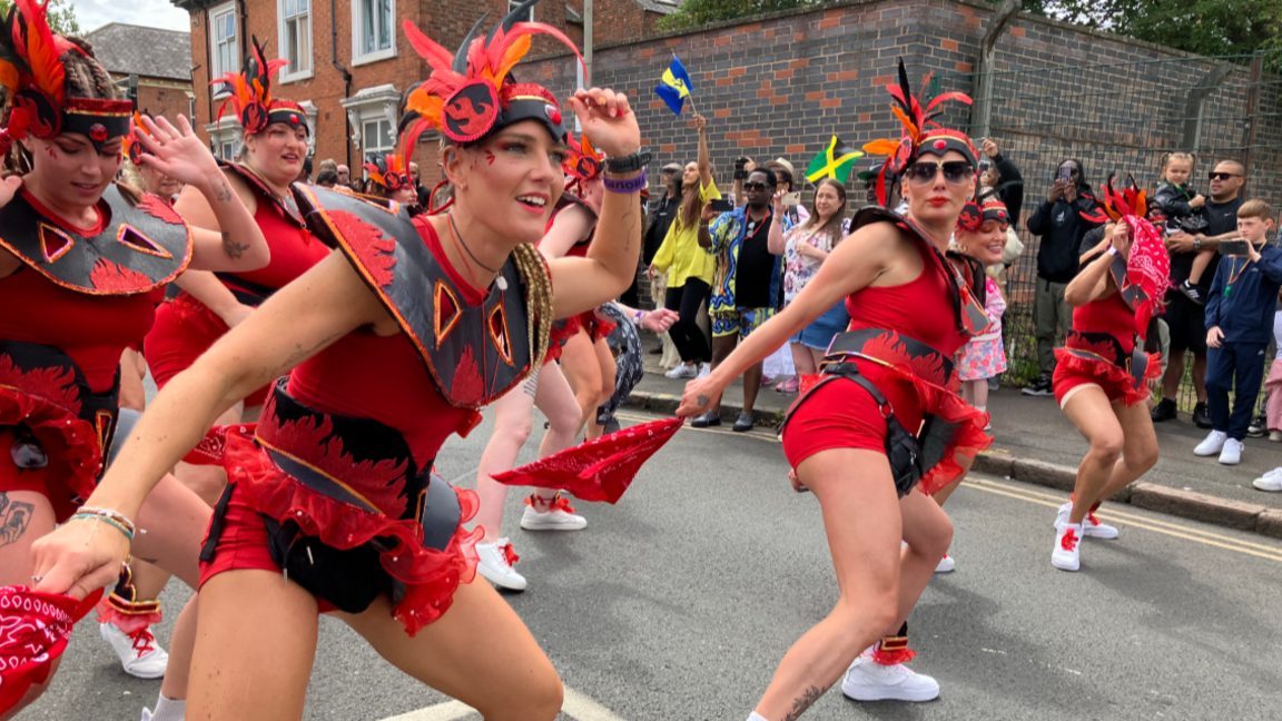 Dancers parade through Leicester with crowds lining the streets for the city's 40th Caribbean Carnival in 2025.
