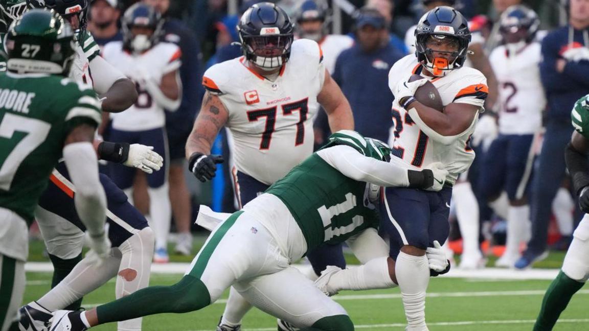 Jermaine Johnson tackles JK Dobbins as the Denver Broncos beat the New York Jets in London