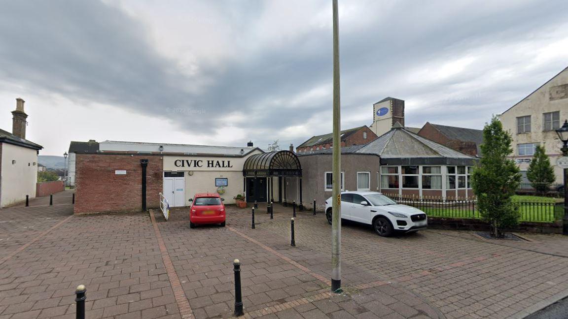 Cleator Moor Civic Hall and Masonic Centre. There are two cars parked outside.