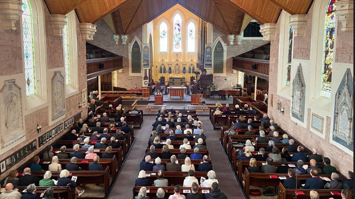 Crowds pictured in the pews inside Christ Church in Oxton, Birkenhead