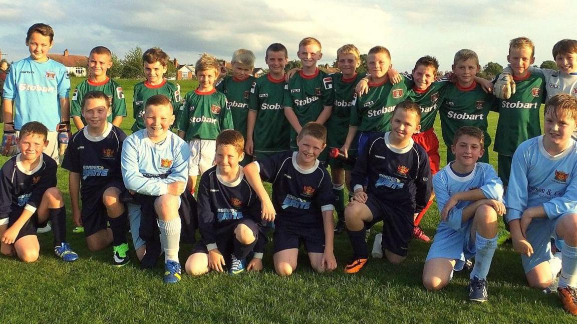 A group of young footballers, which includes James Trafford, pose for a photo