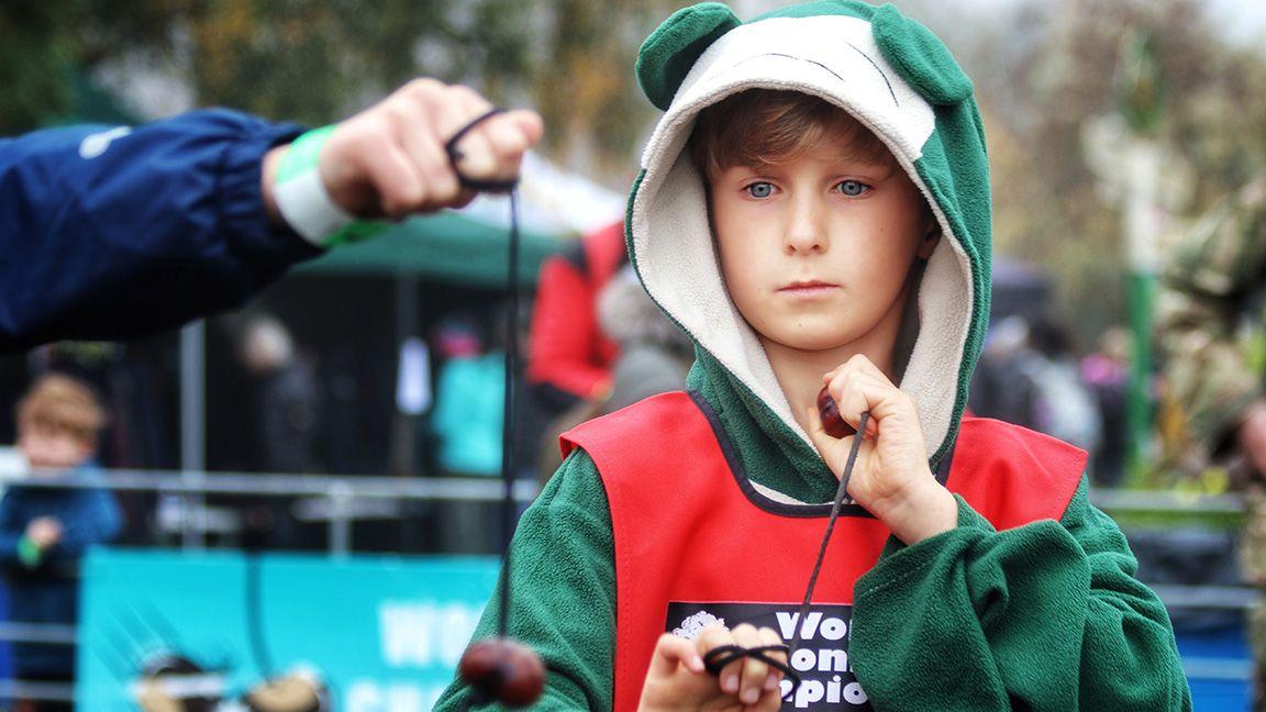 Boy playing a game of conkers.
