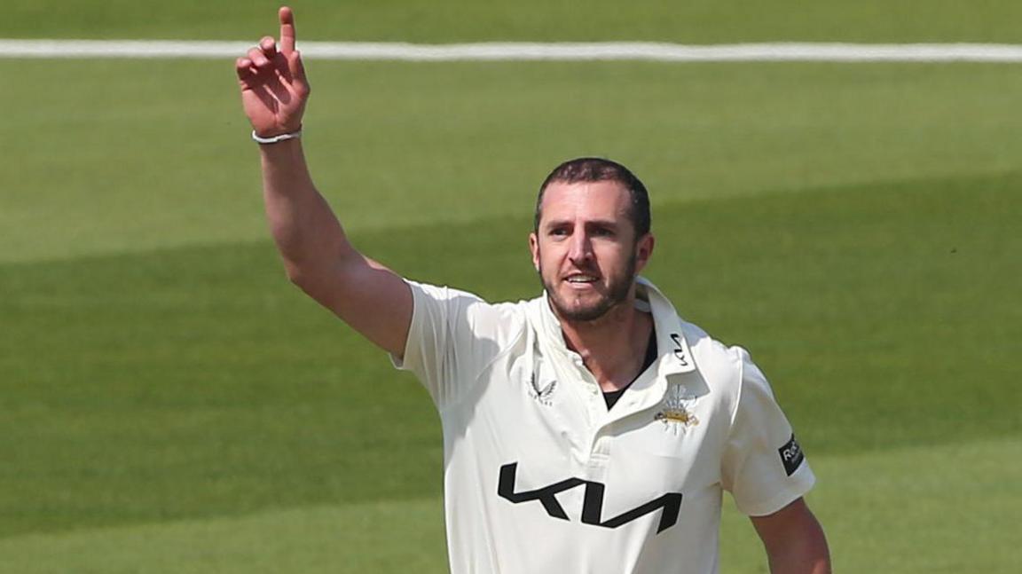 Dan Worrall, index finger raised, celebrates a wicket