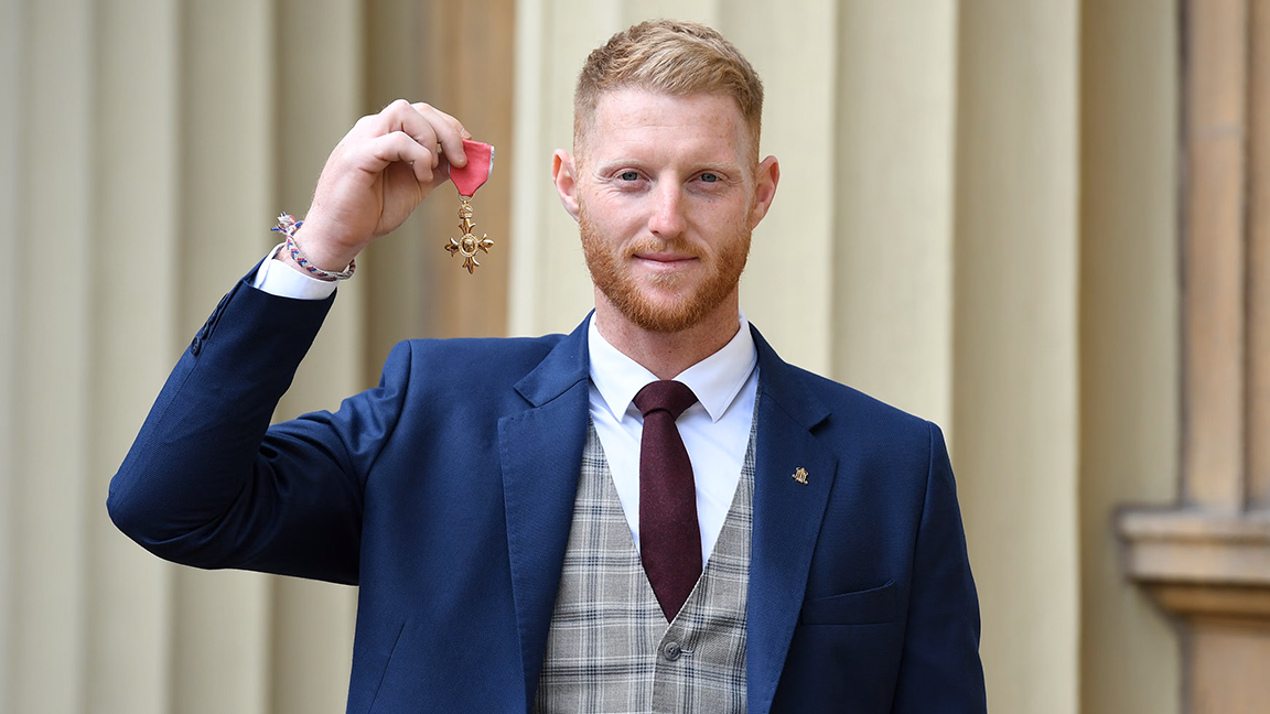 Cricketer Ben Stokes poses with his OBE 