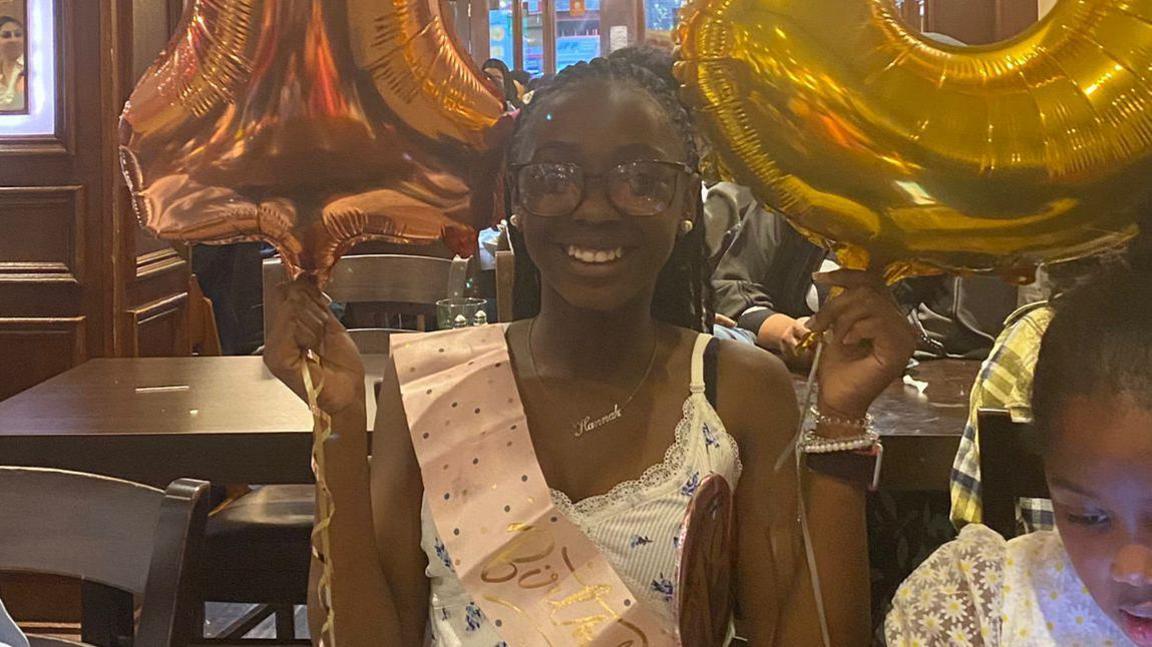 Hannah Jacobs with 13th birthday sash and balloons