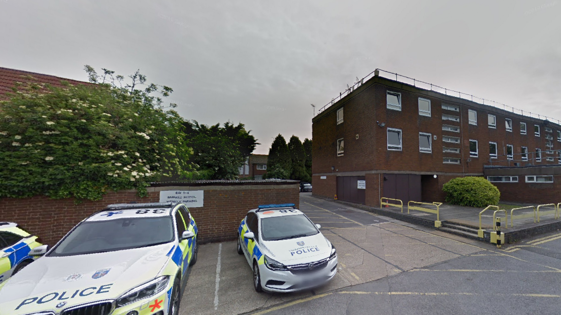 Two police cars parked outside Aylesbury police station