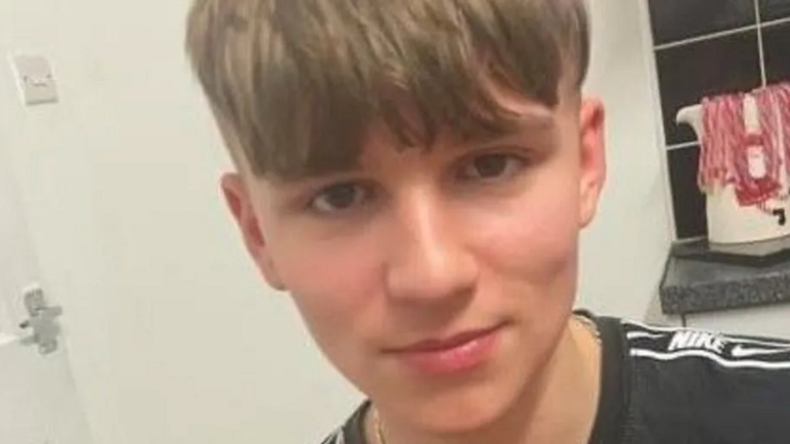 Boy with brown hair in a black Nike T-shirt