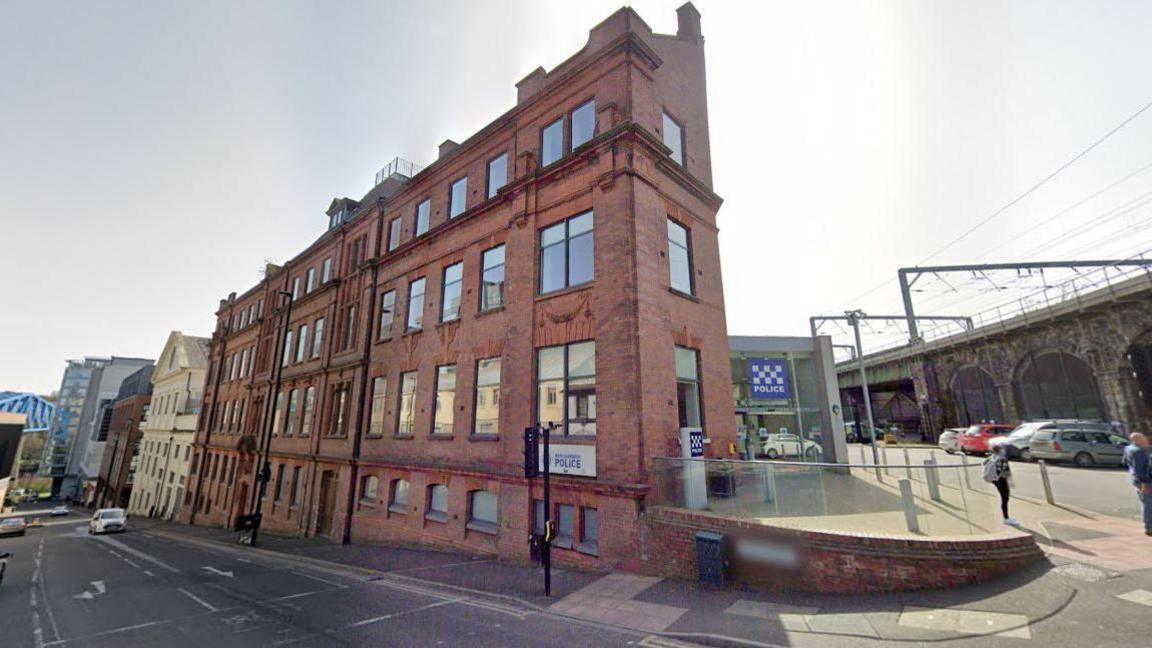 Exterior of Forth Banks police station. It is at the top of a hill and is made of four storeys of red bricks