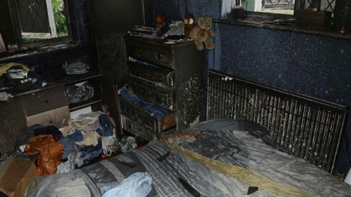 Burnt bed along with clothes and other items