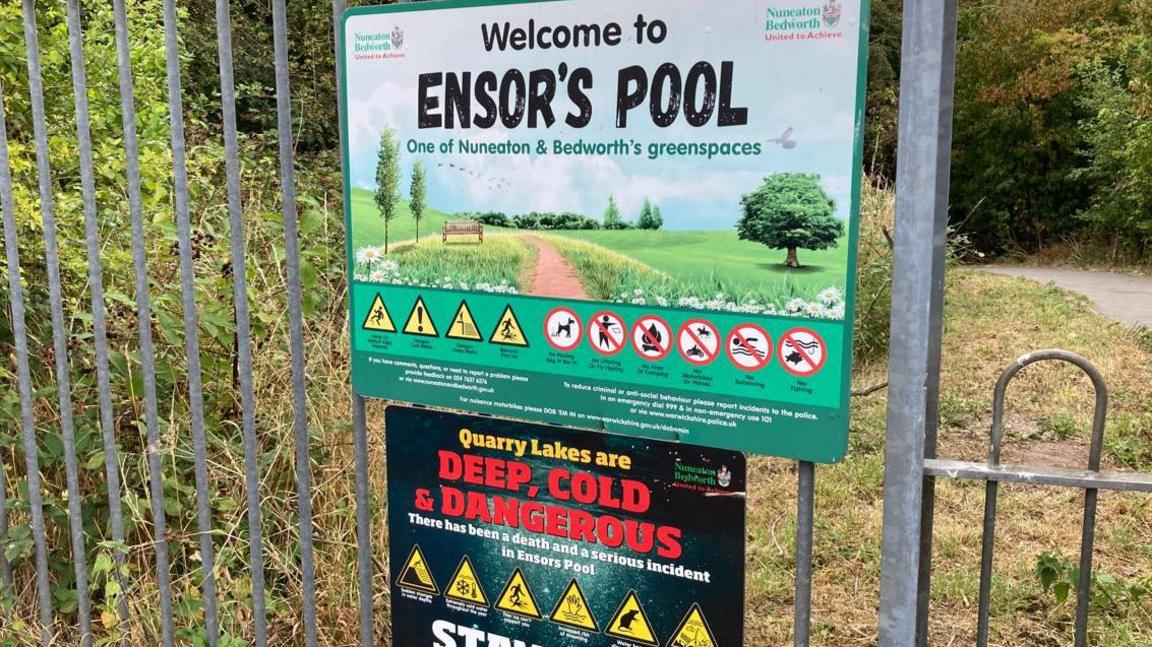 Signs at Ensor's Pool. One reads Welcome to Ensor's Pool. The other is a black sign which details the dangers of quarry lakes.