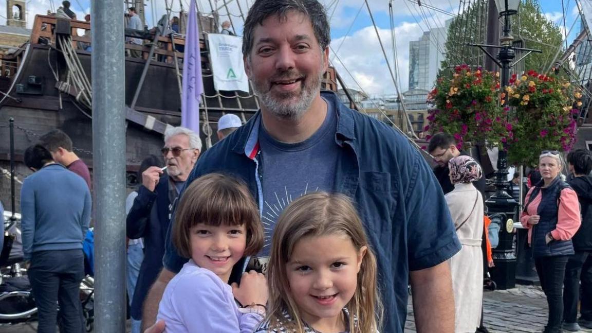 Andy Coley with his daughters, aged five and seven on a day out.