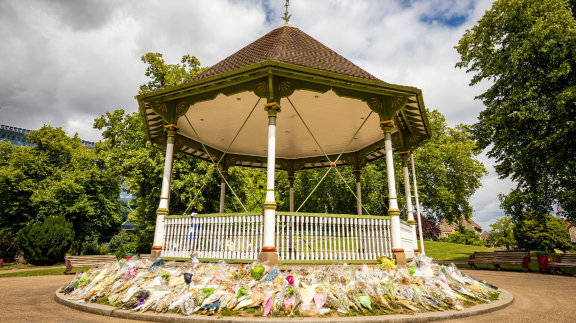 Reading Forbury Garden bandstand with hundreds of flowers layed around it.
