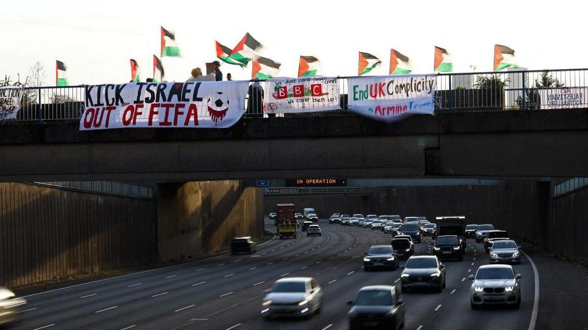 Pro-Palestine supporters display banners and Palestine flags on a bridge above the A38(M) ahead of Aston Villa's UEFA Europa League match against Maccabi Tel Aviv.