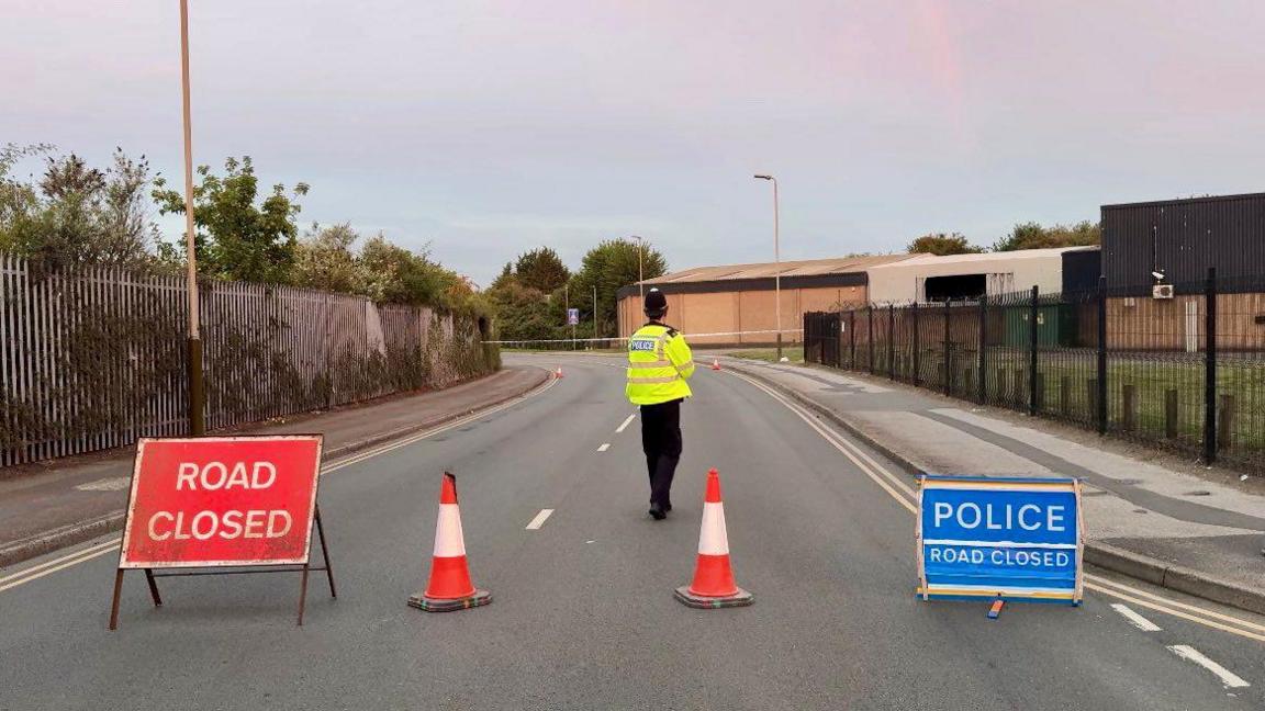 A police officer stands inside the cordon following the incident
