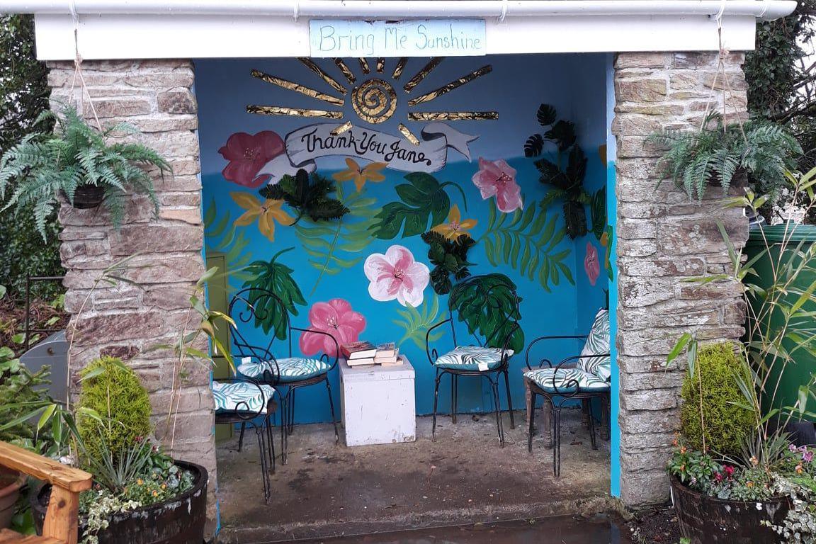 bus stop with flowers painted inside 